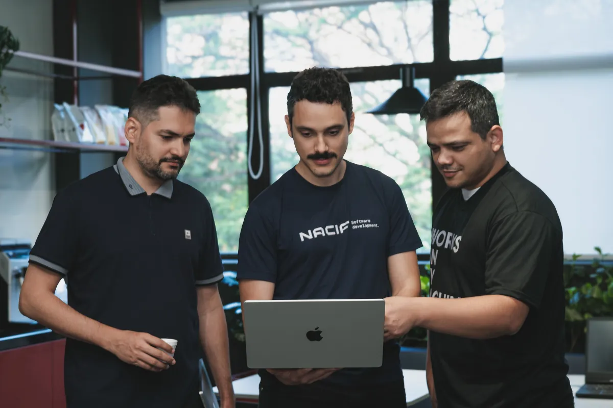 Three Nacif engineers reviewing work together on a laptop